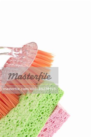 Housecleaning Border Featuring Sponges and a Scrub Brush Isolated on White with a Clipping Path.
