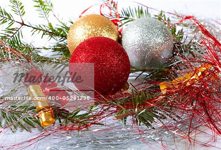 Christmas balls surrounded by green branches and decoration
