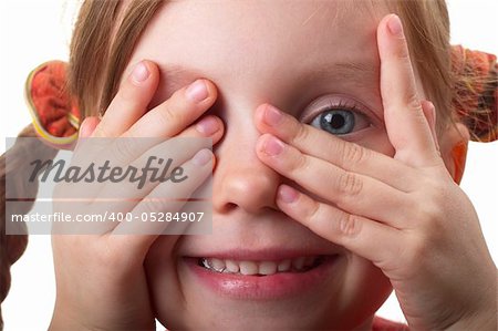 Little girl peeping through hand with one eye isolated over white background