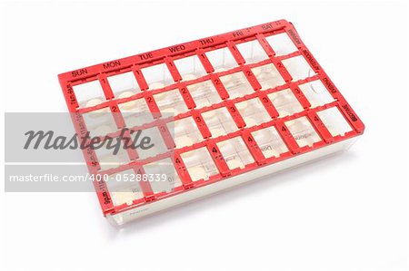 Pills in Pill Box on White Background