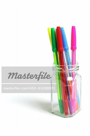 Ballpoint Pens in Glass Jar on White Background