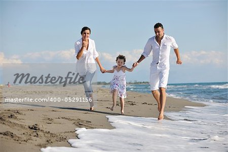 happy young family in white clothing have fun at vacations on beautiful beach