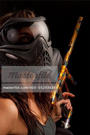 Image of a paintball player in protective helmet