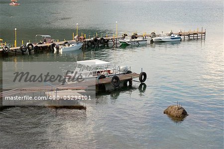 Boats at the wooden dock at sunshine on Black Sea