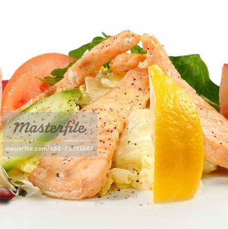 Salmon with vegetables isolated on white. Closeup