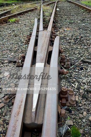 The rusty rails of an abandoned railway section