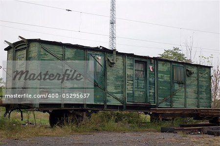 Abandoned, old train made of green plank