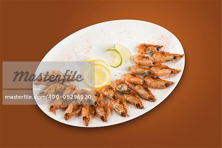 roasted shrimps with lemon isolated on a white background