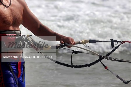 Kitesurfer with equipment on a coast of ocean