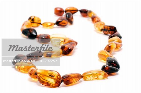Yellow and brown amber necklace, isolated on white background
