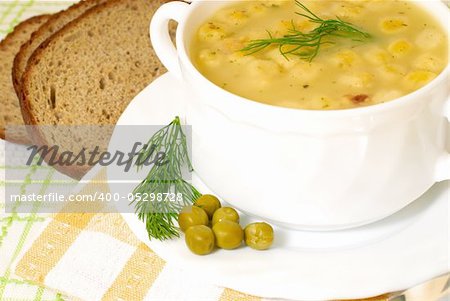 Bowl of homemade pea soup with brown bread