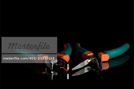 flat nose and needle nose pliers with rubbed green and orange grips