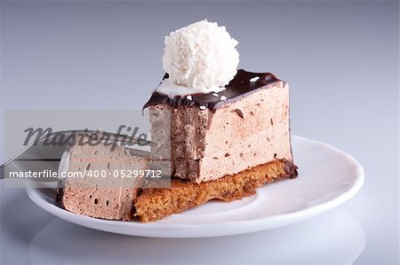 tasty chocolate cake on white plate with fork. Shallow focus