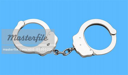 Metal handcuffs isolated on the blue background