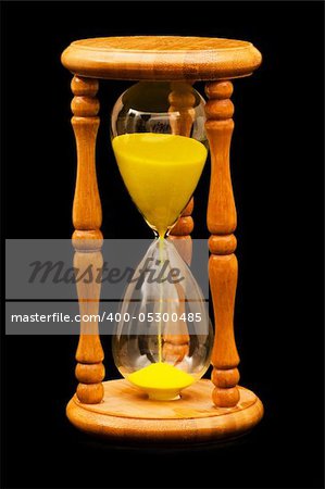 Wooden hourglass isolated on the balck background