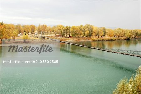 Scenery of a drawbridge over the river in an early autumn morning