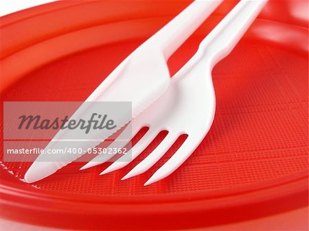 fork and knife in red disposable plate