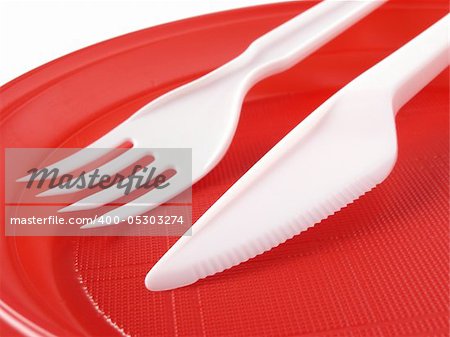 red disposable plate with fork and knife