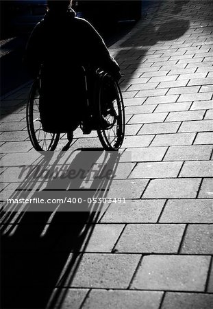 Silhouette of young man i wheelchair