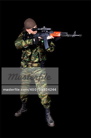 Full length shot of soldier with weapon, isolated on black background