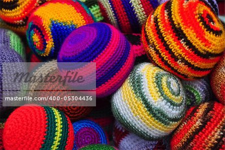 close up of brightly coloured woolen juggling balls