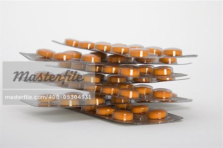 Packs of orange pills isolated on white background.