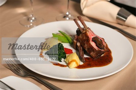 restaurant table with a plate of lamb meal