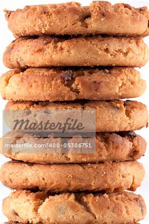 Close up of a tower of freshly baked delicious chocolate chip cookies just out of the oven. A lot of Calories but it taste so good. White background