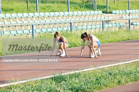 young girl morning run and competition on athletic race track