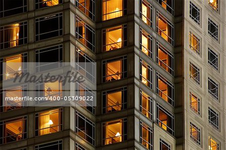 Apartment background with windows light in night.