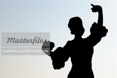 Silhouette of a Spanish dancer when clapping the castanets against the ligth