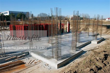 Construction site with enforced concrete steel frames rising up