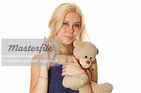 Young attractive woman holding in the arms of Teddy.  Isolated on white