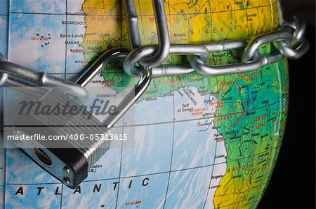 Metal lock and chain on a globe.