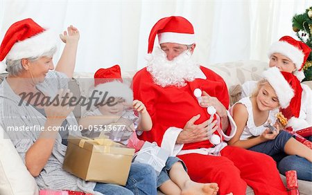 Santa Claus with a happy family on Christmas day