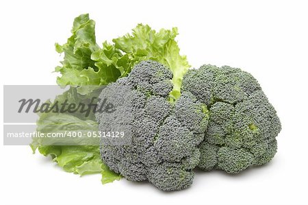 Broccoli and leafs of salad isolated on white background