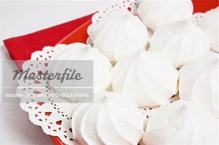 Delicious sweet meringue kiss-cake on red plate