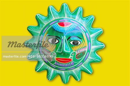 Mexican indian sun handcraft ceramic isolated in yellow background