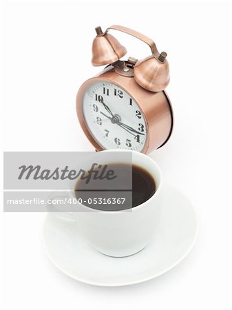 vintage alarm clock and white coffee cup