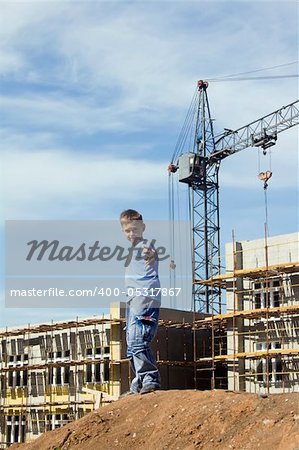 Little boy playing on a building area