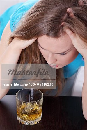 Young corpulent woman in depression, drinking alcohol