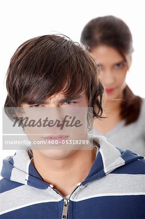 Young beaten up caucasian man standing in front of angry young woman. Couple fight. Isolated on white