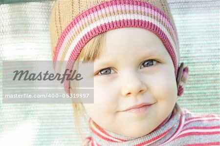 Cute little girl with knit hat outdoors