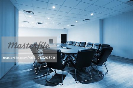 a large table and chairs in a modern conference room