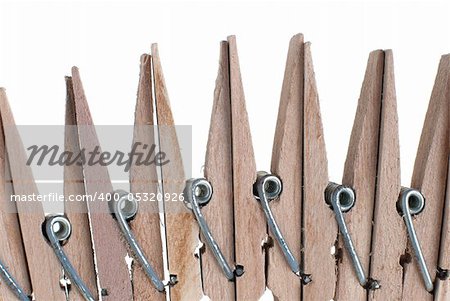 Wooden clothes pegs isolated on white background.