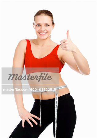 Slim sporty woman showing thumb up sign after loosing weight.