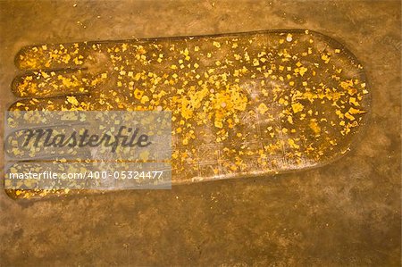 sacred footprint of Buddha with gold foil on it