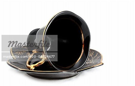 Black cup and saucer isolated on white background