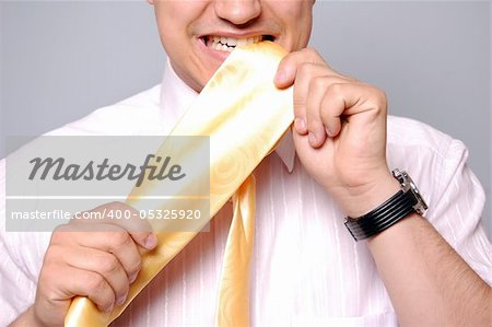 Young men could't select tie. Studio shot.