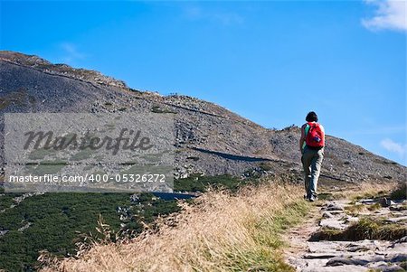 hiking tourist going to the mountain top